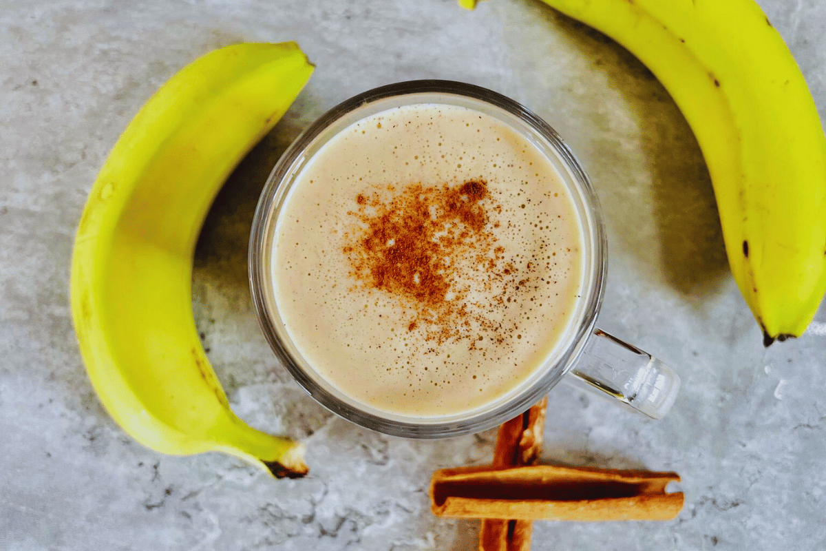 Banana and Yogurt Smoothie For Weight Loss surrounded by whole bananas and cinnamon sticka