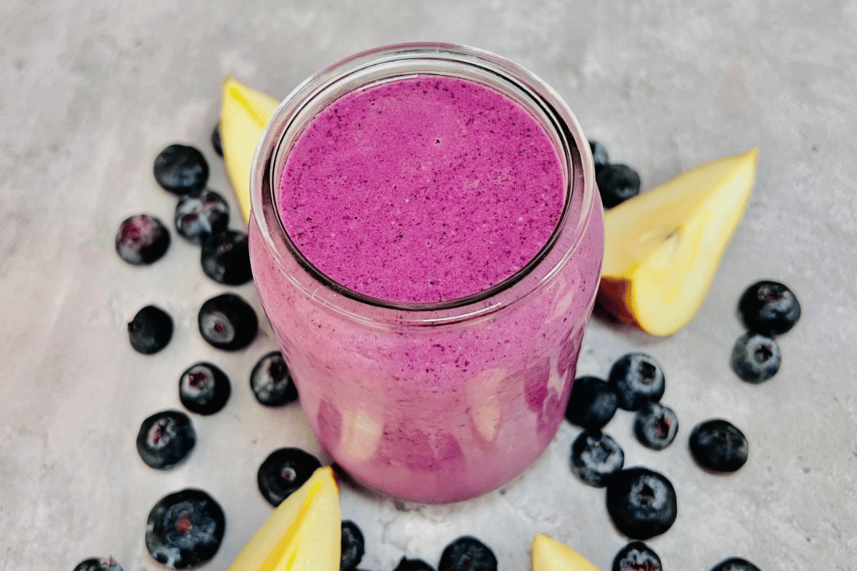 glass cup filled with blueberry and pear smoothie