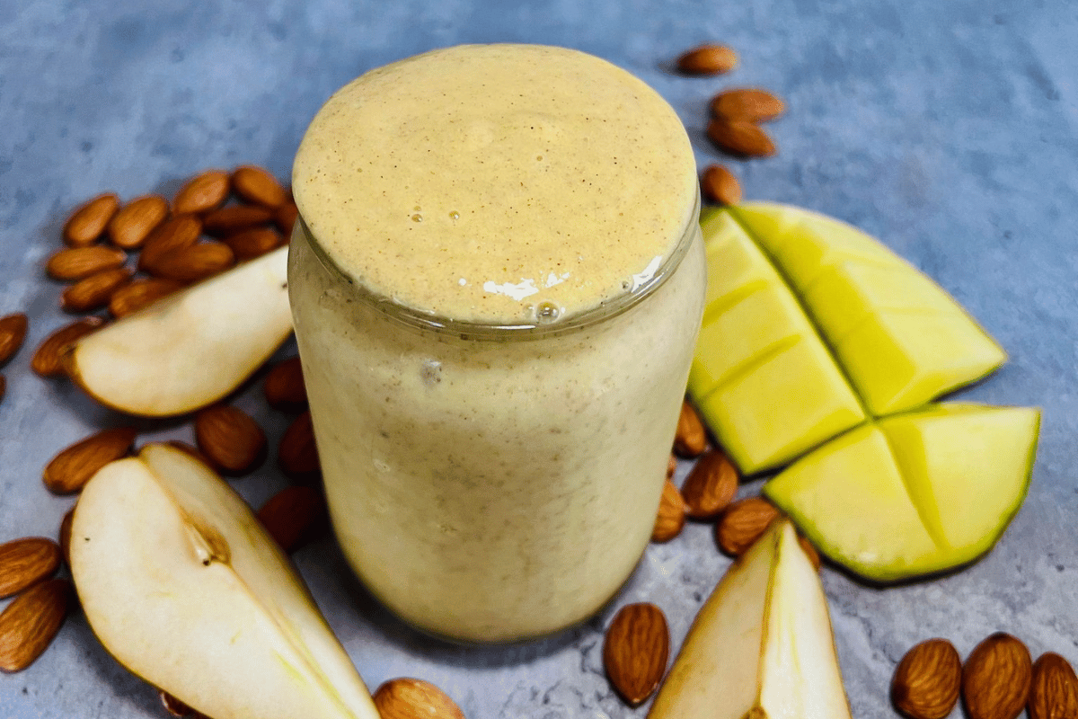 Mango And Pear Smoothie served in a tall glass cup