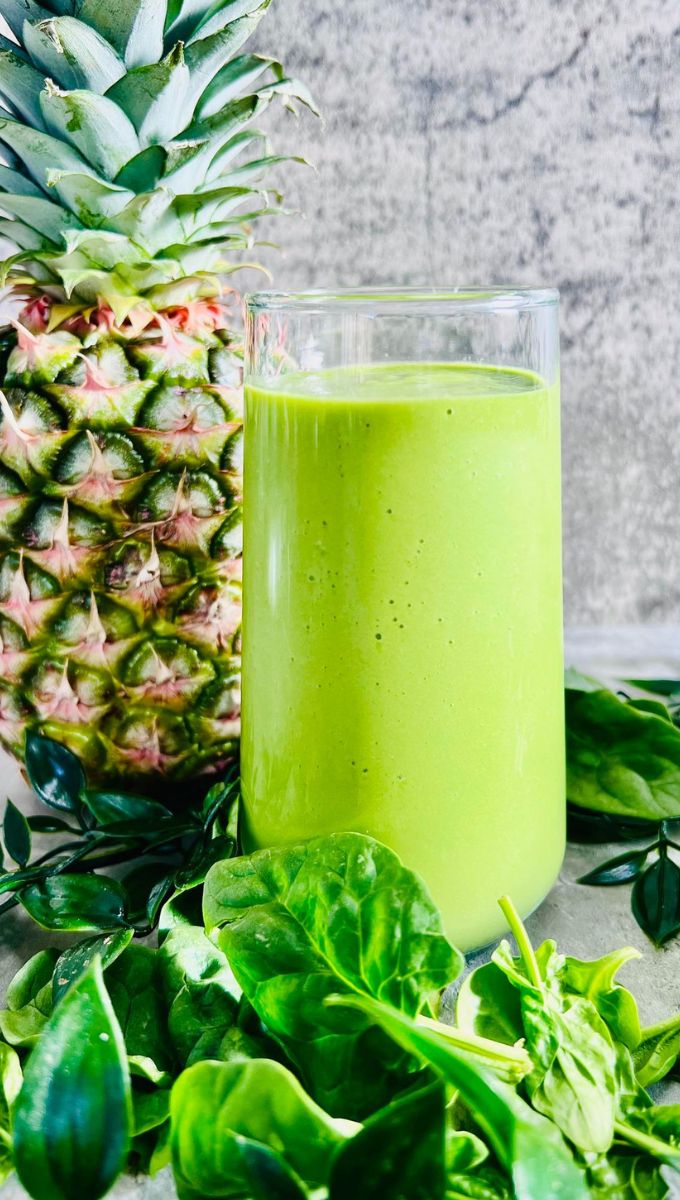 Pineapple Spinach Smoothie Served in a tall thin glass cup