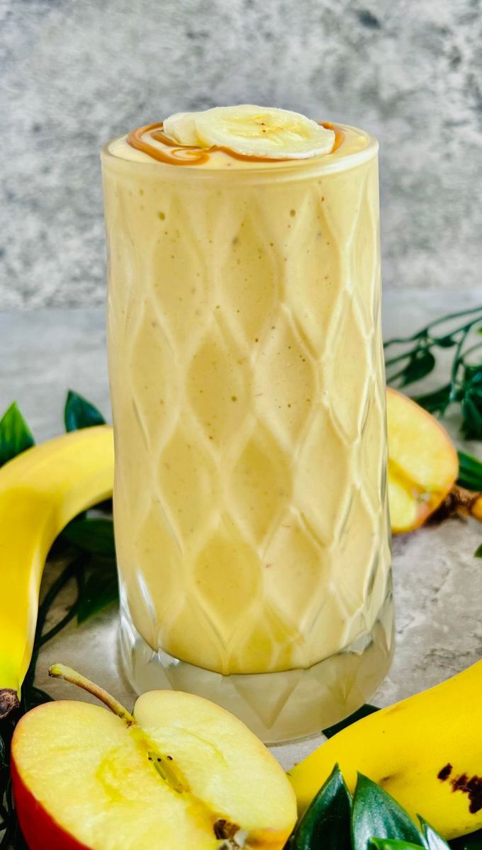 Banana And Apple Smoothie served in a tall thick glass cup