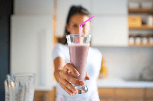woman drinking a smoothie
