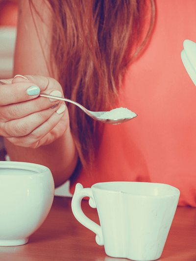 Woman holding a spoon of sugar