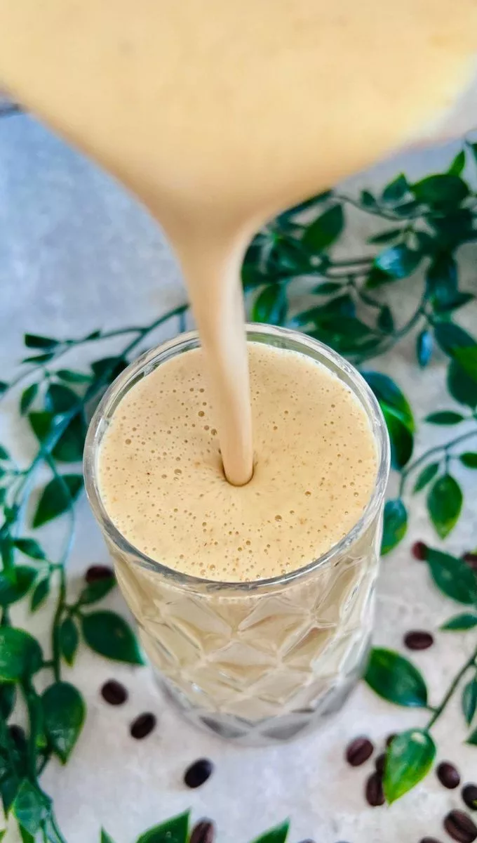 Coffee Smoothie For Weight Loss being poured into a tall thick glass cup