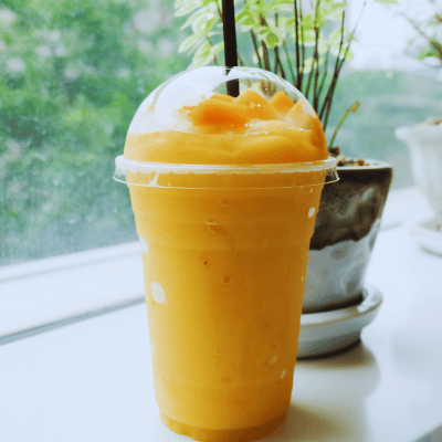 Mango drink in a takeaway cup
