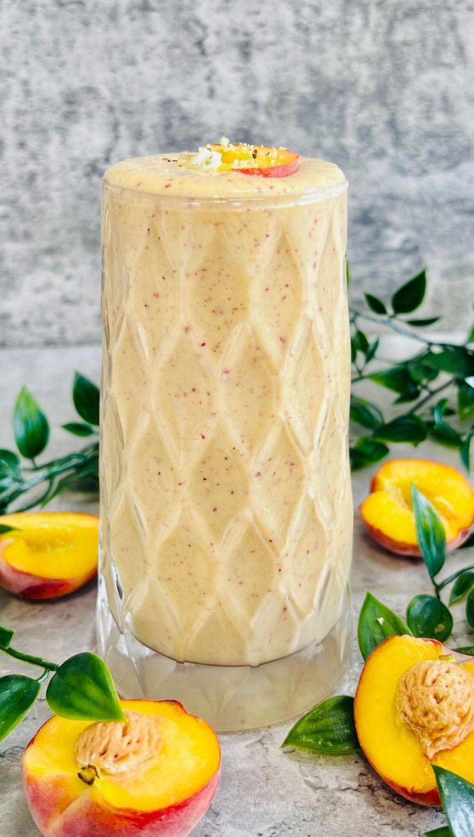 Peach Smoothie With Yogurt served in a tall thick glass cup