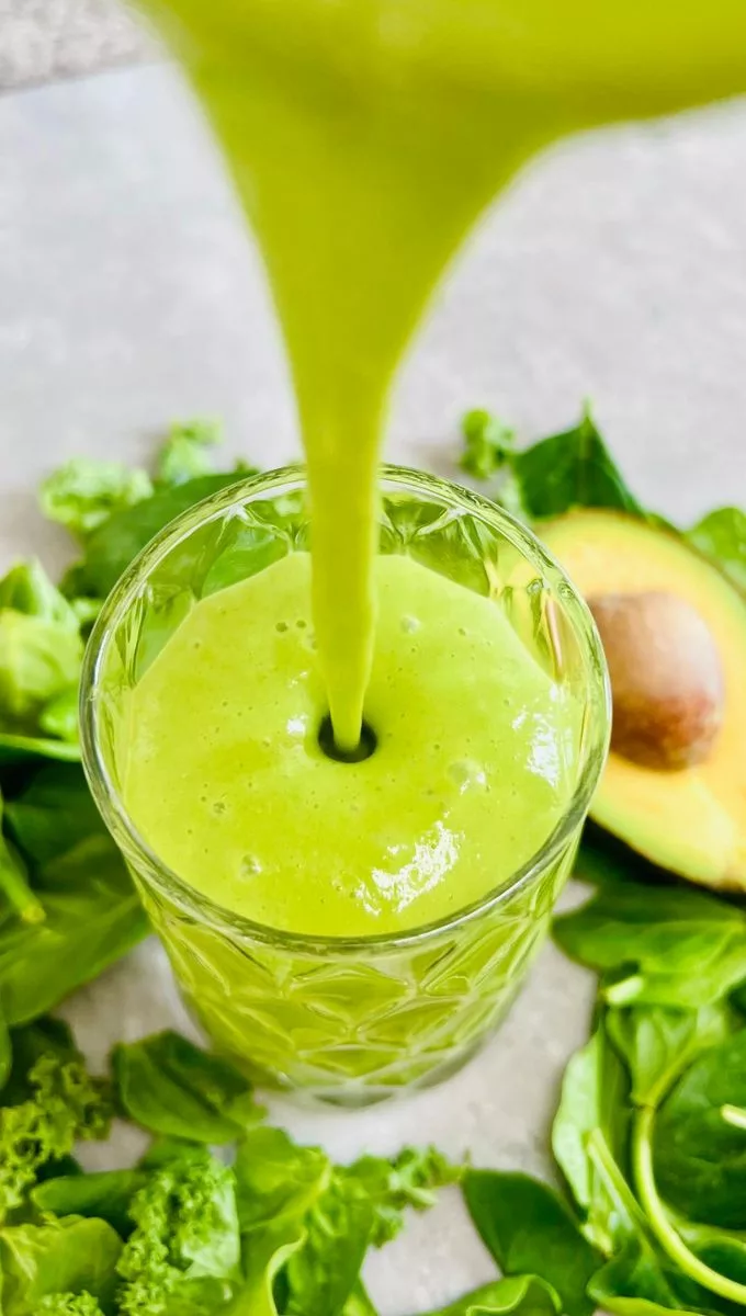 Spinach And Kale Smoothie being poured into a glass cup