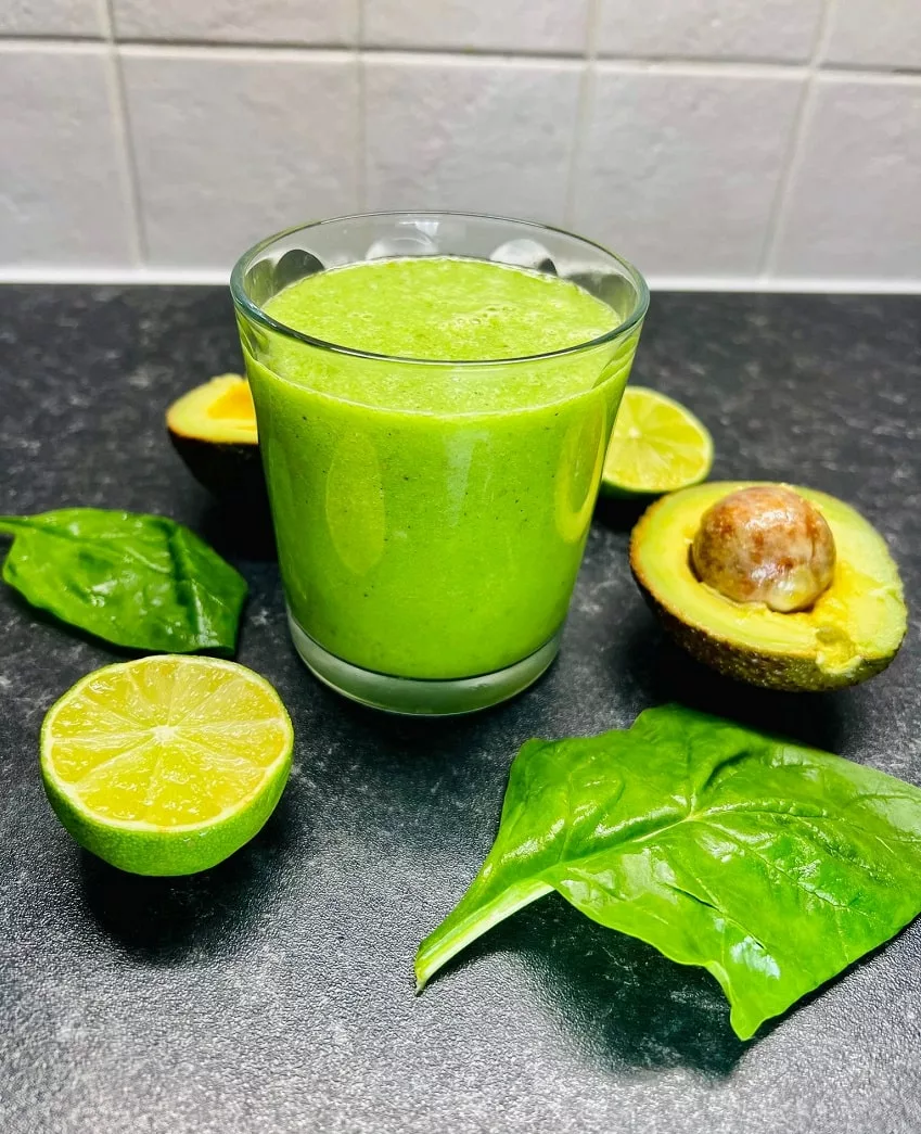Jackfruit Smoothie surrounded by spinach lime and avocado