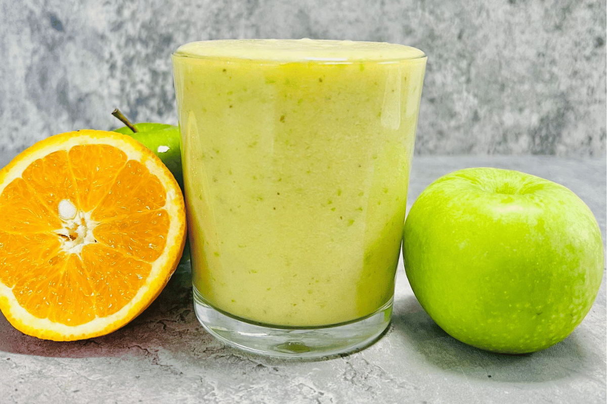 Apple And Orange Smoothie served in glass cup