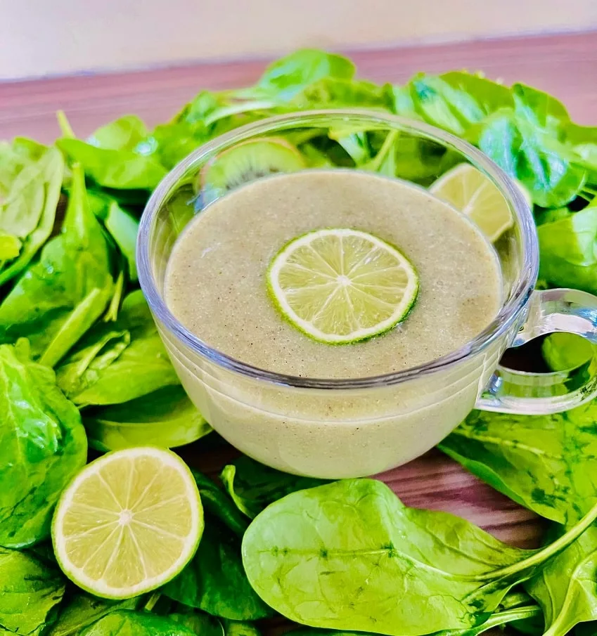 Sugar Detox Smoothie surrounded by spinach and a sliced lime