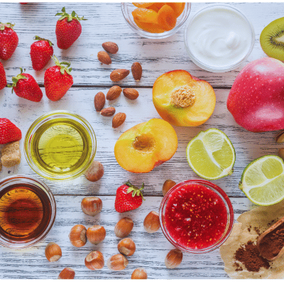 a table full of smoothie ingredients such as fruit and nuts