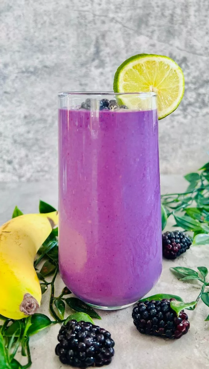 Banana Blackberry Smoothie served in a tall glass cup
