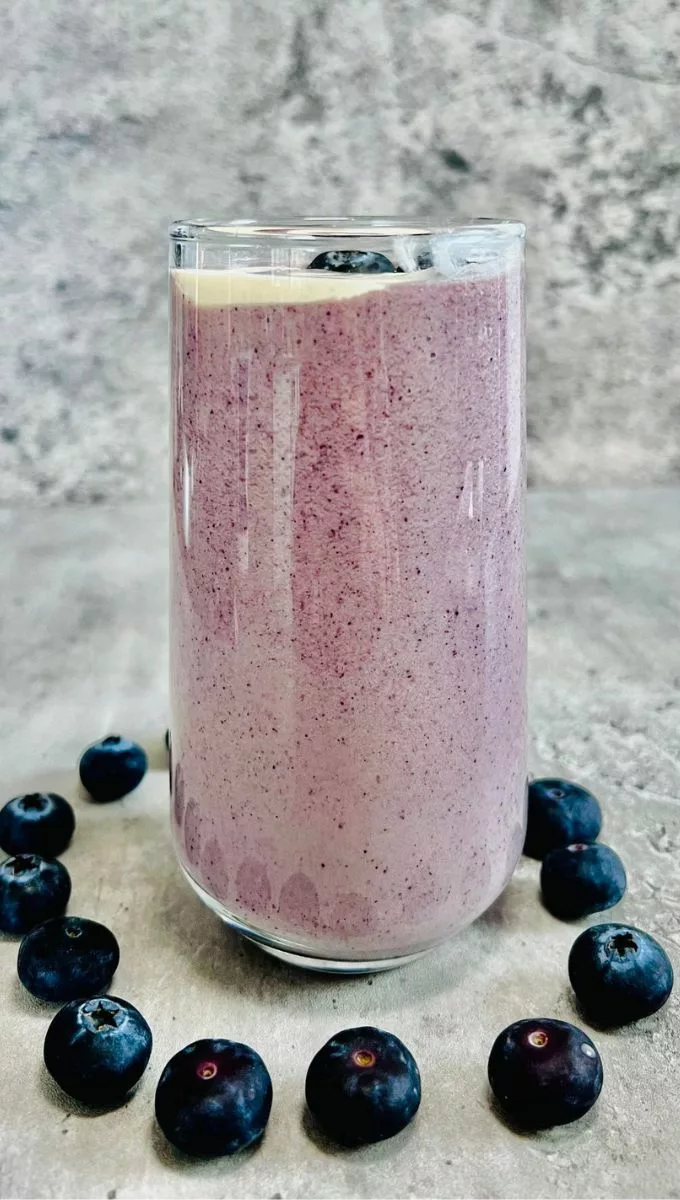 Keto Heavy Cream Smoothie surrounded by blueberries