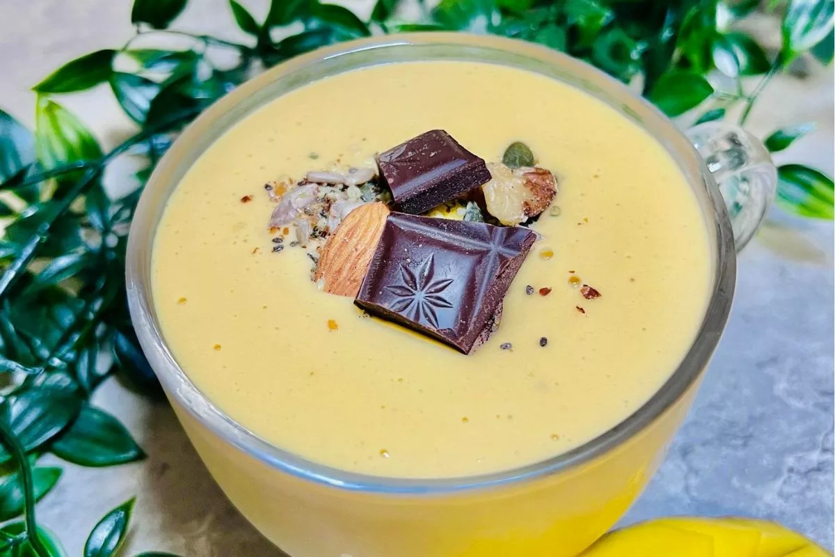 Mango Smoothie Variation Topped With Seeds Nuts And Chocolate