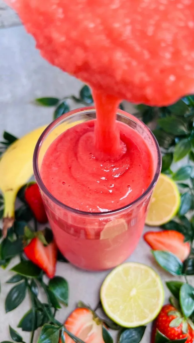 Naked Strawberry Banana Smoothie being poured into a glass cup