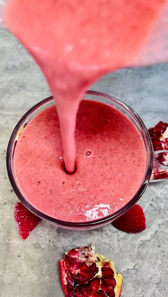 Pomegranate Smoothie being poured into a glass cup