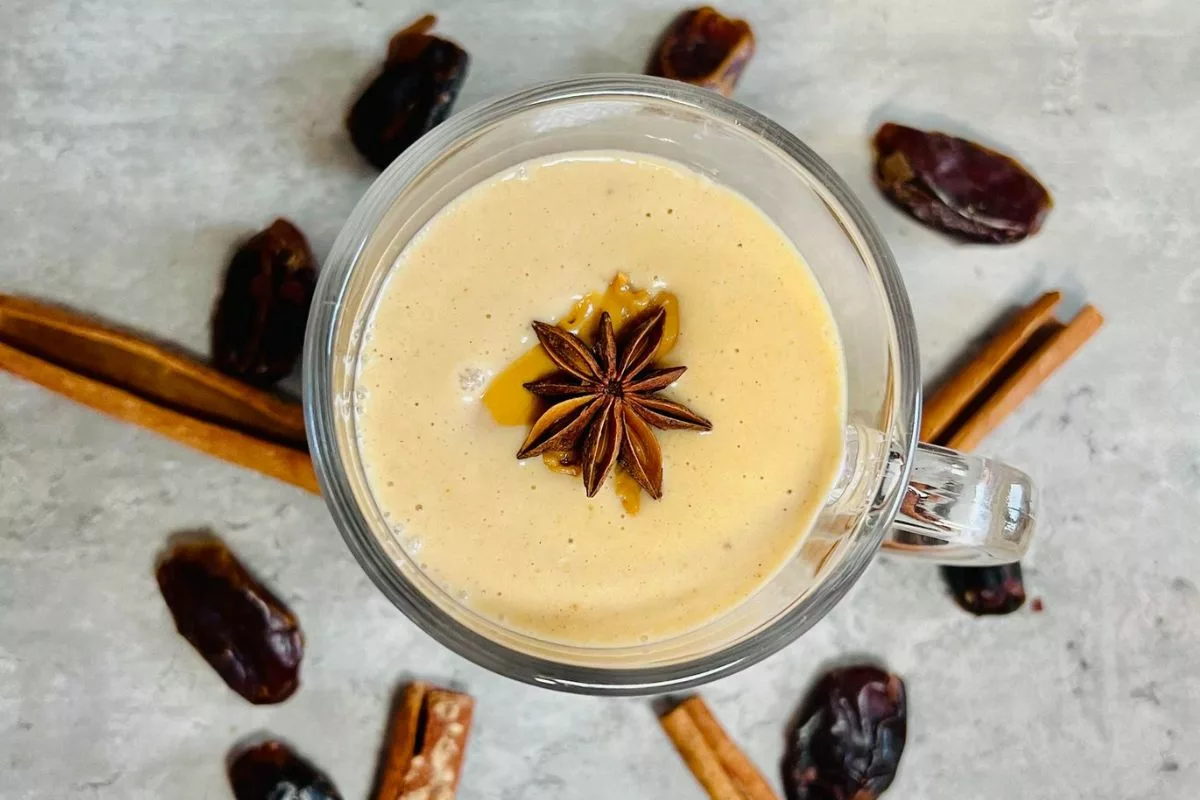 a peanut butter and banana smoothie with a star anise on top