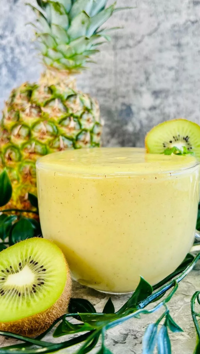 a side picture of a glass filled with Pineapple Kiwi Smoothie