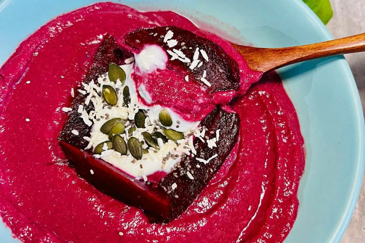 a spoonfull of beetroot smoothie served in a bowl