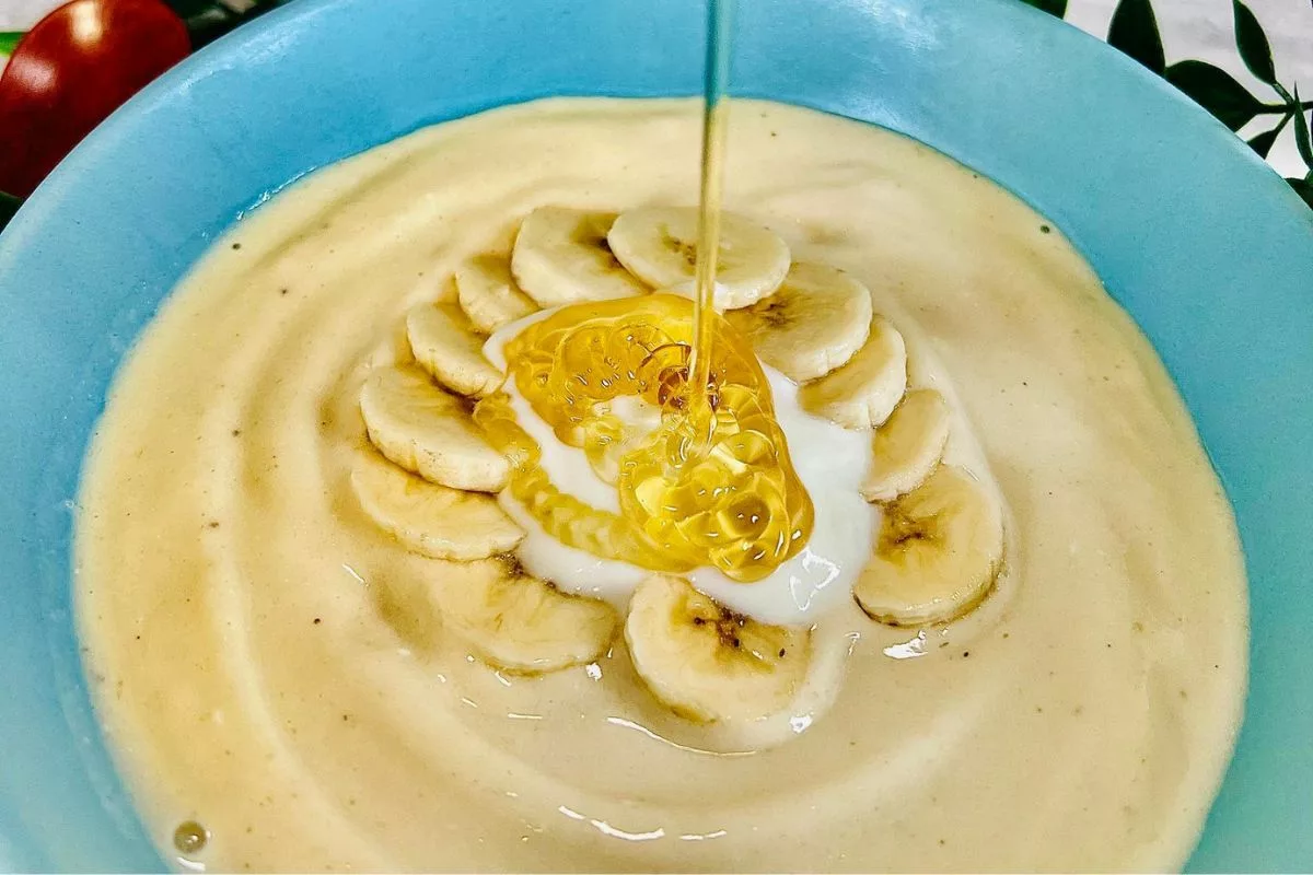 honey being drizzled onto a Cottage Cheese Smoothie Bowl