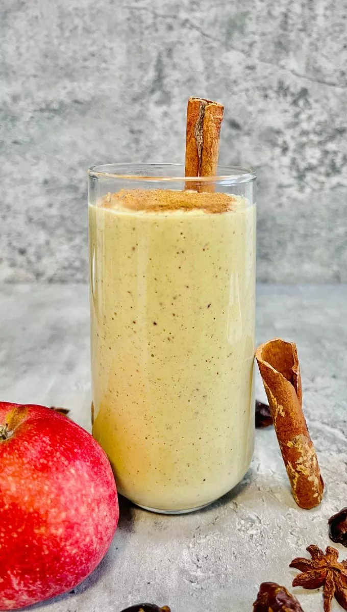 Apple Cinnamon Smoothie surrounded by dates apple and cinnamon sticks