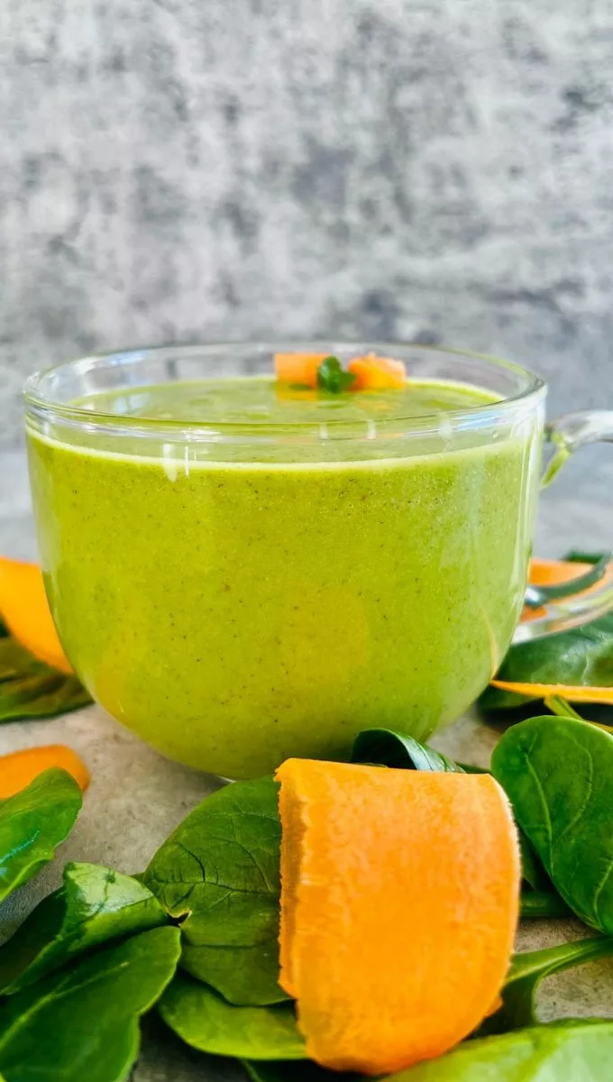 Carrot Spinach Smoothie served in a round glass cup