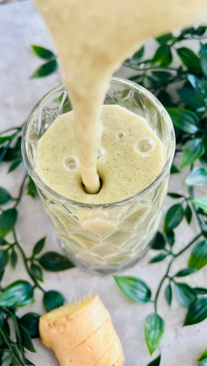 Ginger Pineapple Smoothie being pured into a glass cup