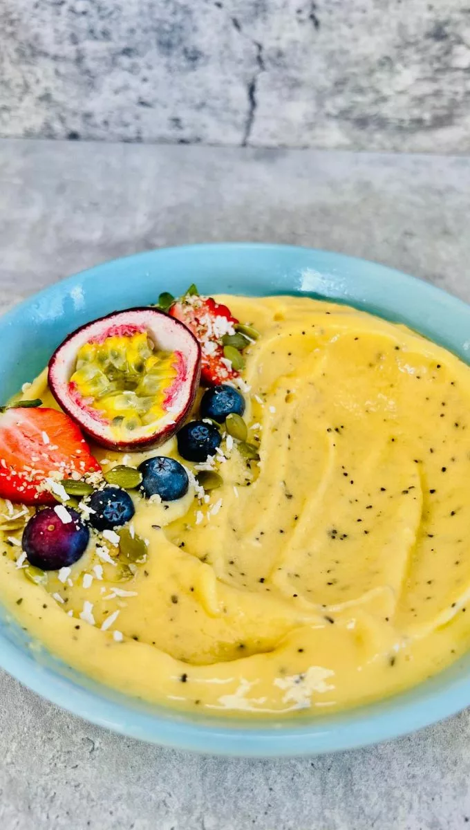 Passionfruit Smoothie Bowl served in a round blue bowl