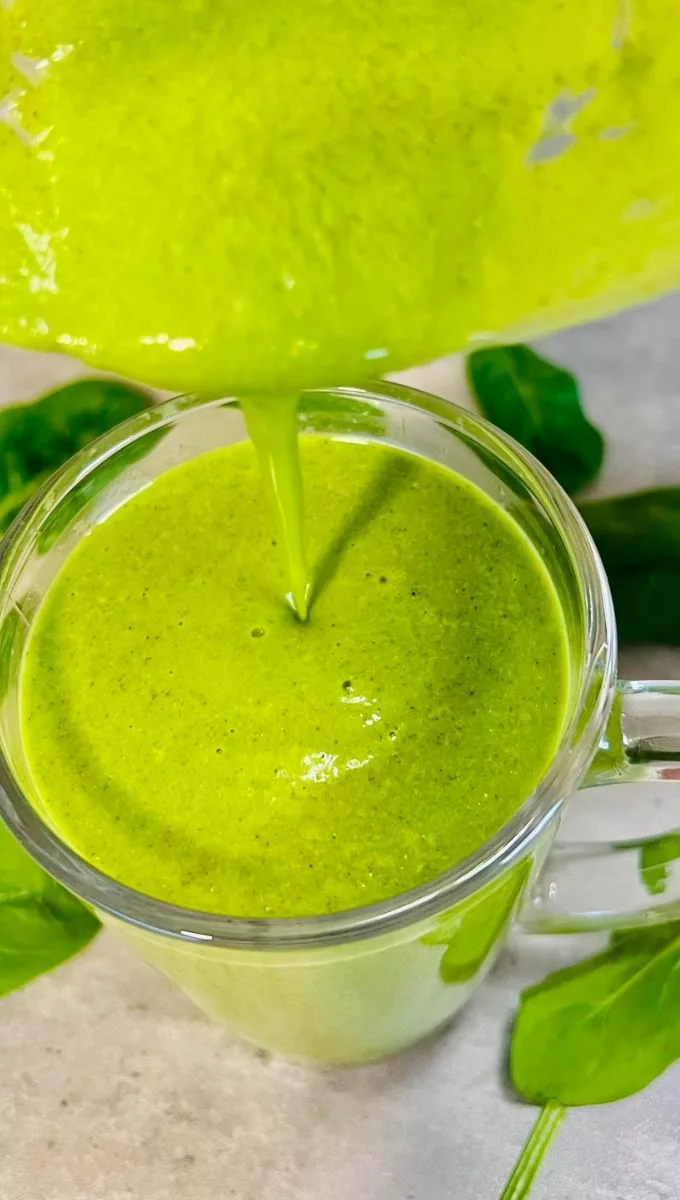 Spinach Smoothie For Weight Loss being poured into a glass cup