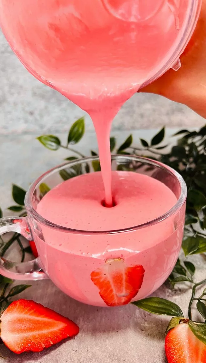 Strawberry Kefir Smoothie being poured into a glass cup