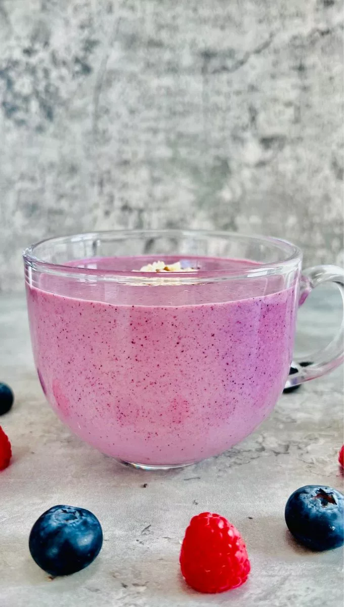 a round glass cup filled with a pink smoothie