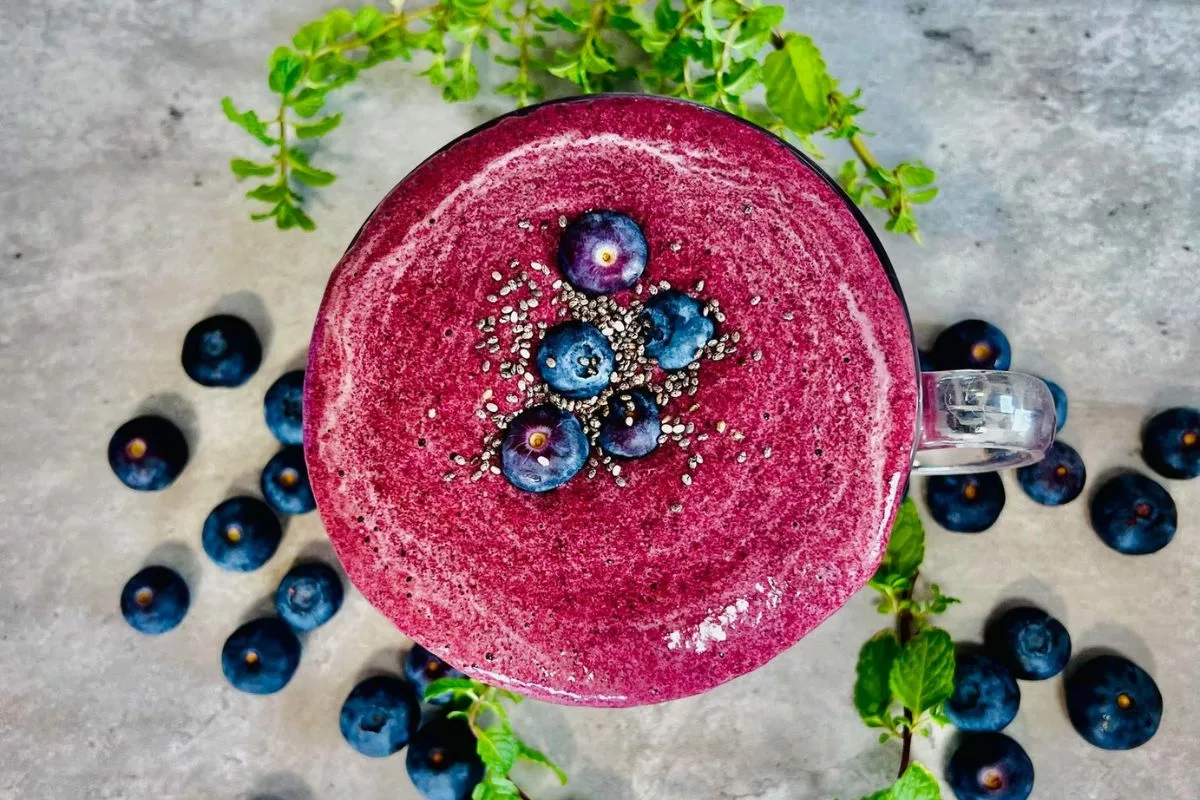 blueberry collagen smoothie topepd with fresh berries and chia seeds