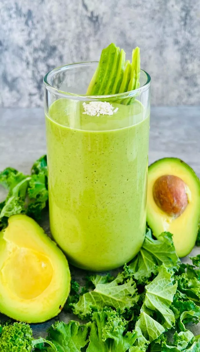 green smoothie made with avocado and coconut water served in a glass cup