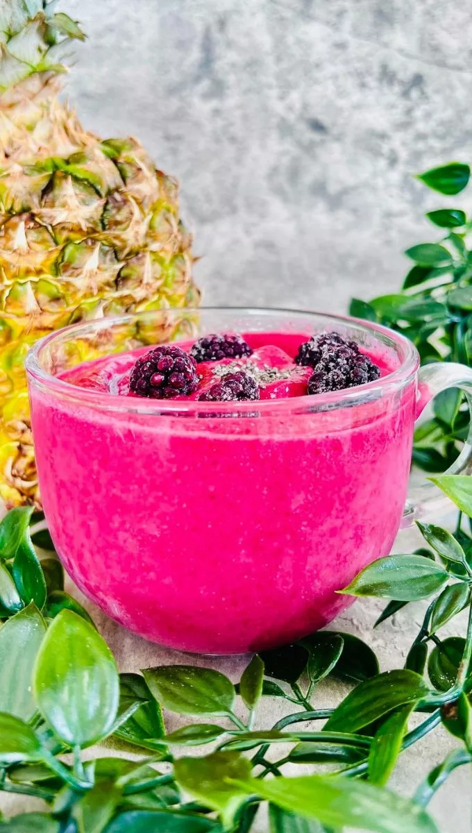 Blackberry Pineapple Smoothie in a thick round glass cup
