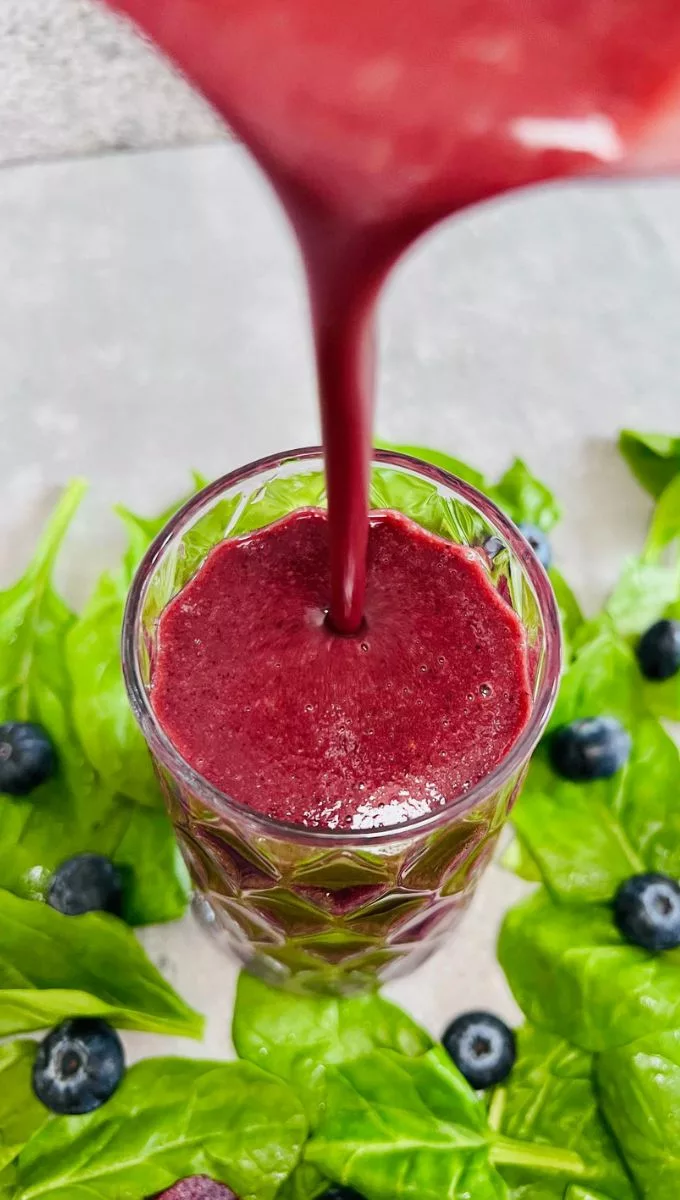 Blueberry Beetroot Smoothie being poured into a glass cup