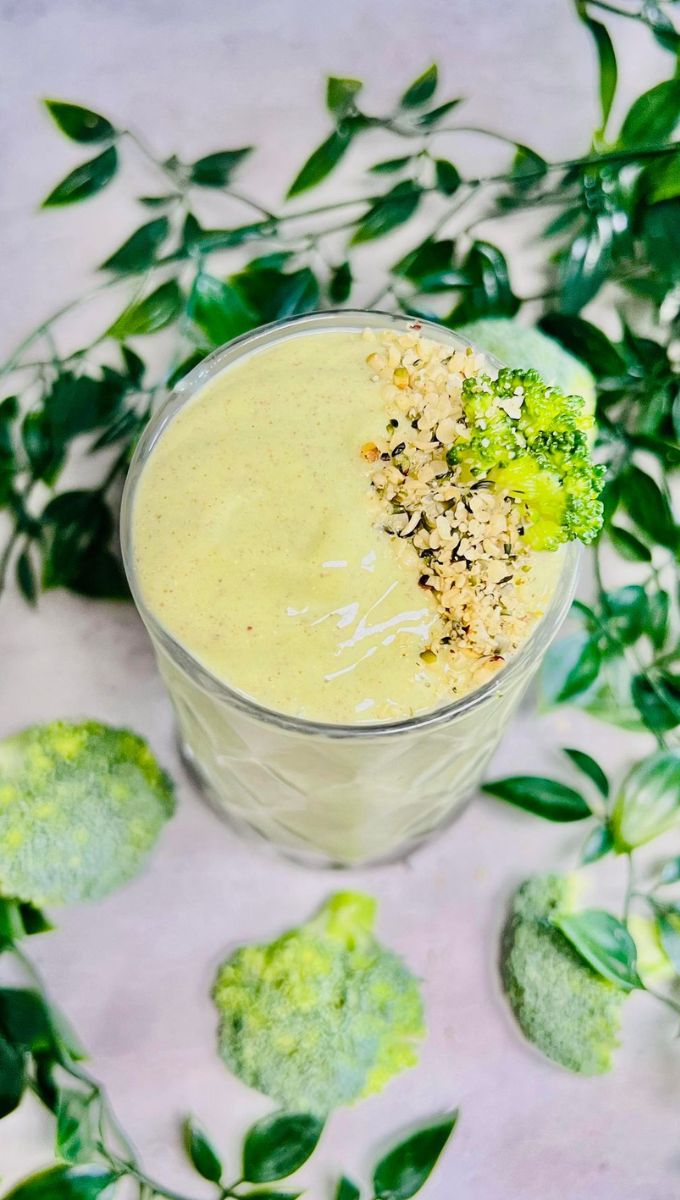 Broccoli Smoothie For Weight Loss served in a large glass cup topped with seeds and broccoli florets