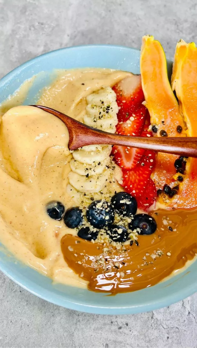Papaya Smoothie Bowl topped with fresh fruit and seeds