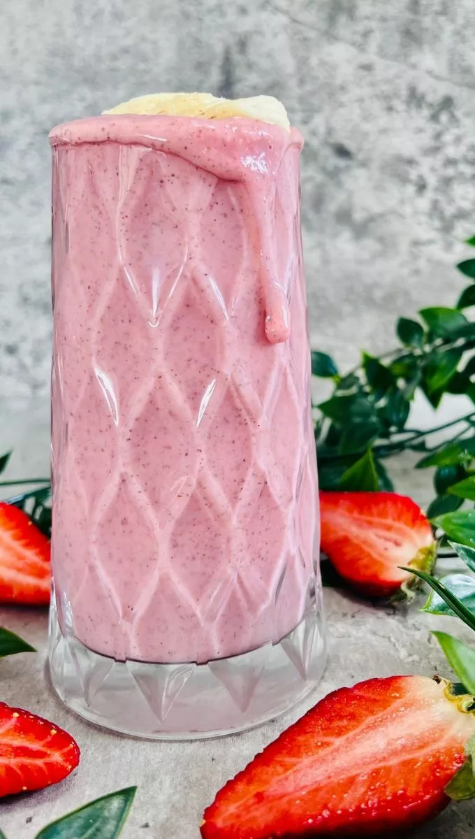 Strawberry Pineapple Banana Smoothie served in a tall thick glass cup