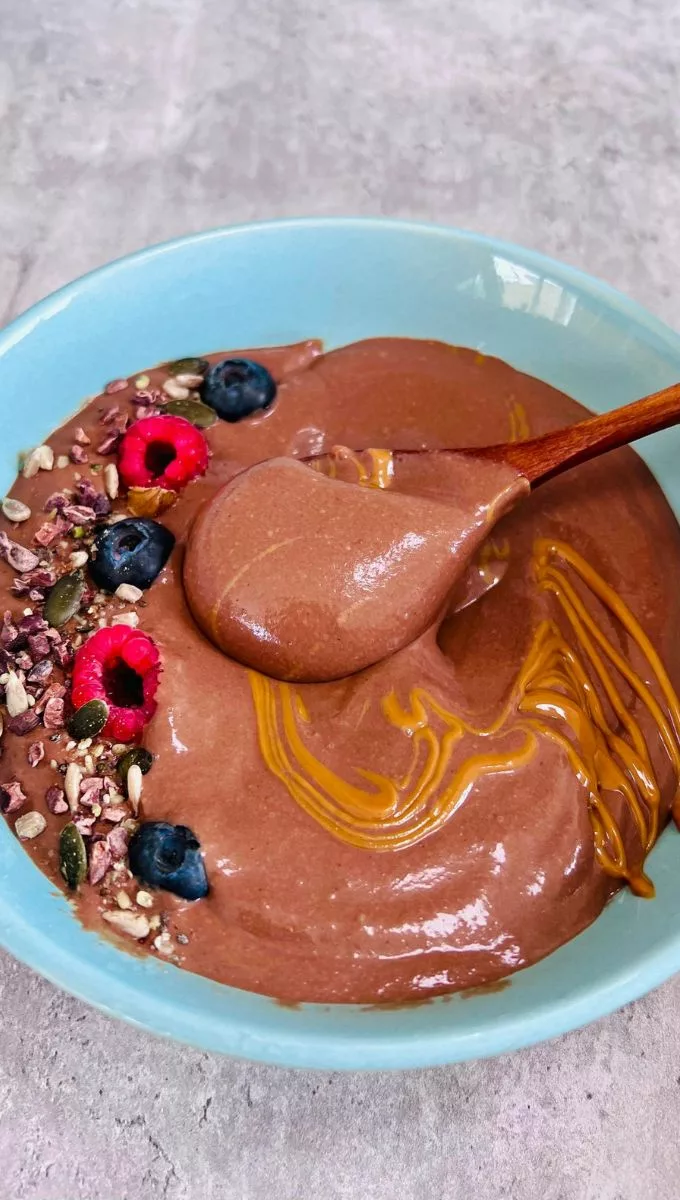 A spoonful of a chocolate smoothie bowl
